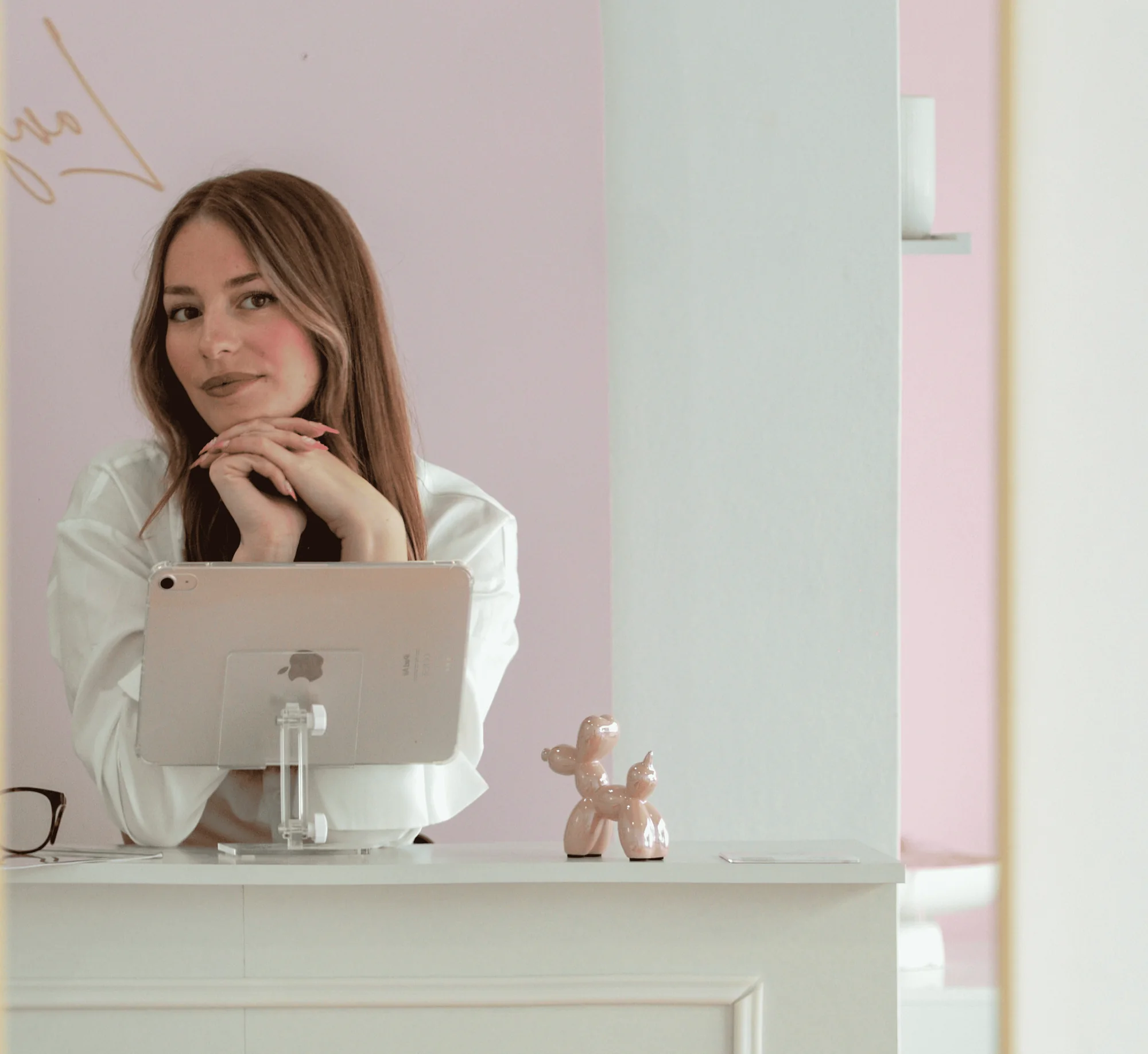 Formatrice Langourbeauty accoudée au comptoir du salon, derrière une tablette